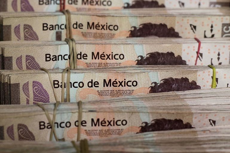 Bundles of Mexican Peso banknotes are pictured at a currency exchange shop in Ciudad Juarez, Mexico January 15, 2018