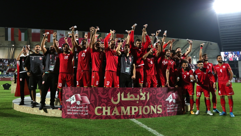 Bahrain players and coaching staff celebrate winning the Gulf Cup after the match