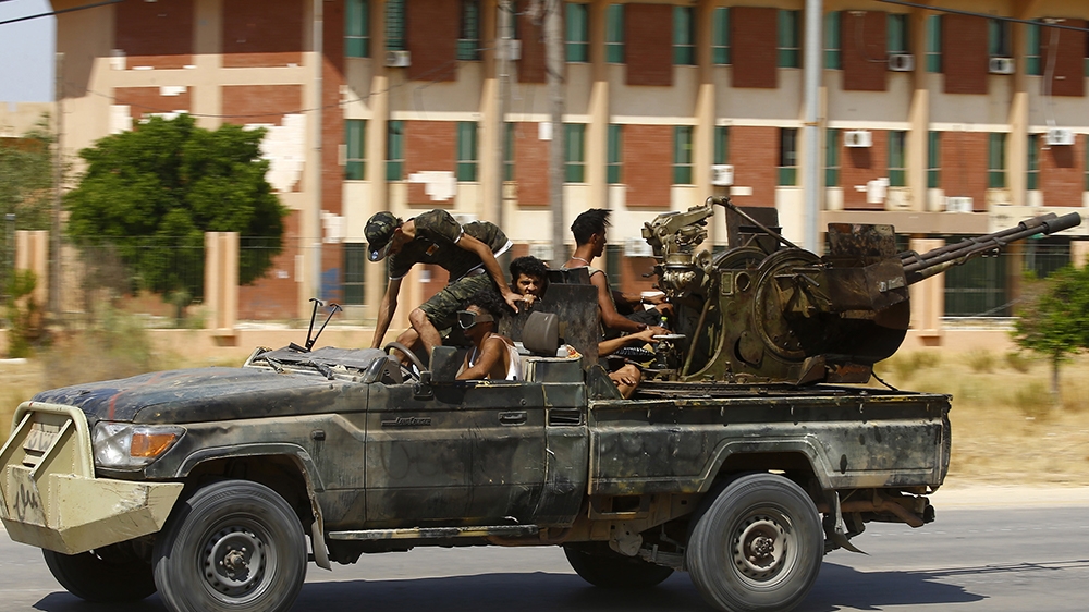 Fighters loyal to the UN-recognised Government of National Accord (GNA), geare transported on board of a military vehicle  during clashes with forces loyal to strongman Khalifa Haftar, in Espiaa, abou