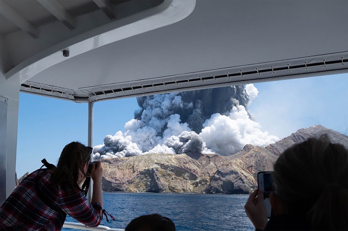 This handout photograph courtesy of Michael Schade shows the volcano on New Zealand''s White Island spewing steam and ash moments after it erupted on December 9, 2019. New Zealand police said at least