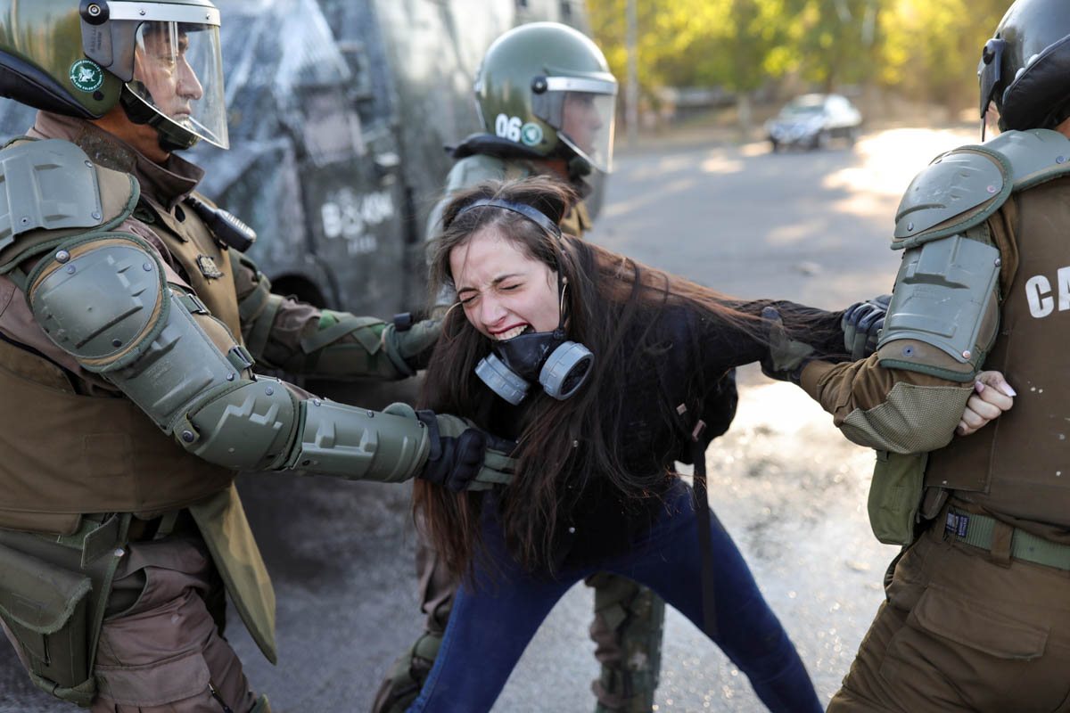 A demonstrator reacts as she is detained by riot policemen during a protest against Chile's government in Santiago, Chile, November 30, 2019. REUTERS/Pablo Sanhueza TPX IMAGES OF THE DAY