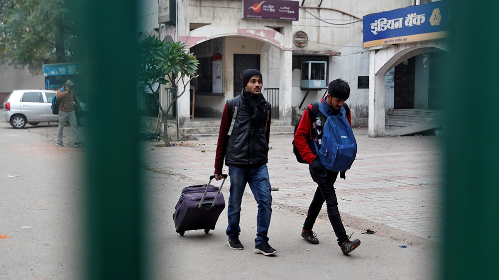 Students of the Jamia Millia Islamia university carrying their belongings leave the university campus in New Delhi, India, December 16, 2019. REUTERS/Adnan Abidi