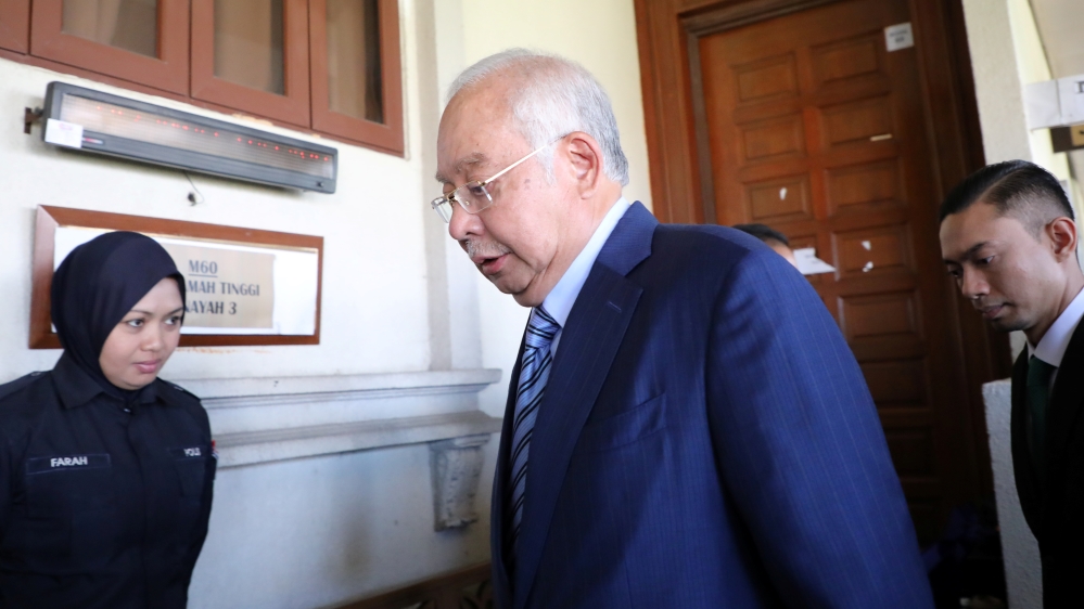 Former Malaysian Prime Minister Najib Razak walks in to a courtroom at Kuala Lumpur High Court in Kuala Lumpur
