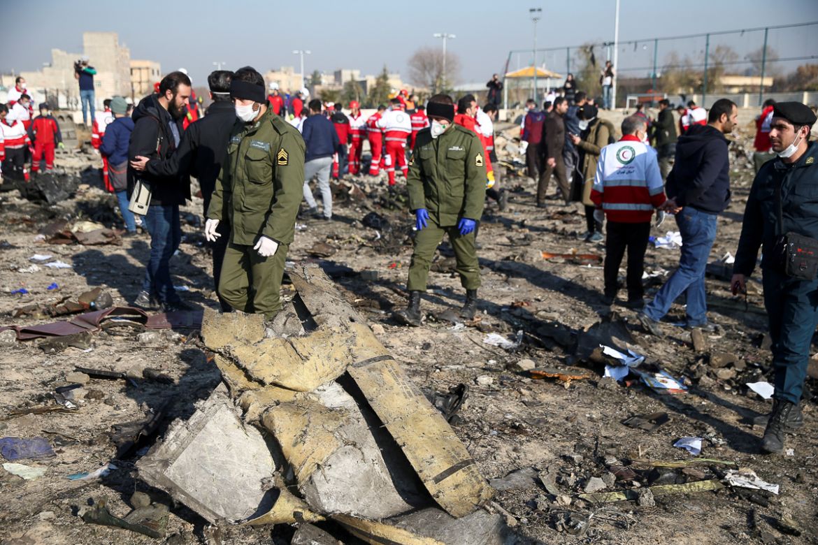 Security officers and Red Crescent workers are seen at the site where the Ukraine International Airlines plane crashed after take-off from Iran''s Imam Khomeini airport, on the outskirts of Tehran, Ira