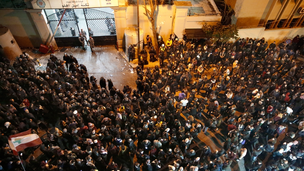 Anti-government protesters gather outside a police headquarters, as they demand the release of those taken into custody the night before, outside a police headquarter, in Beirut, Lebanon, Wednesday