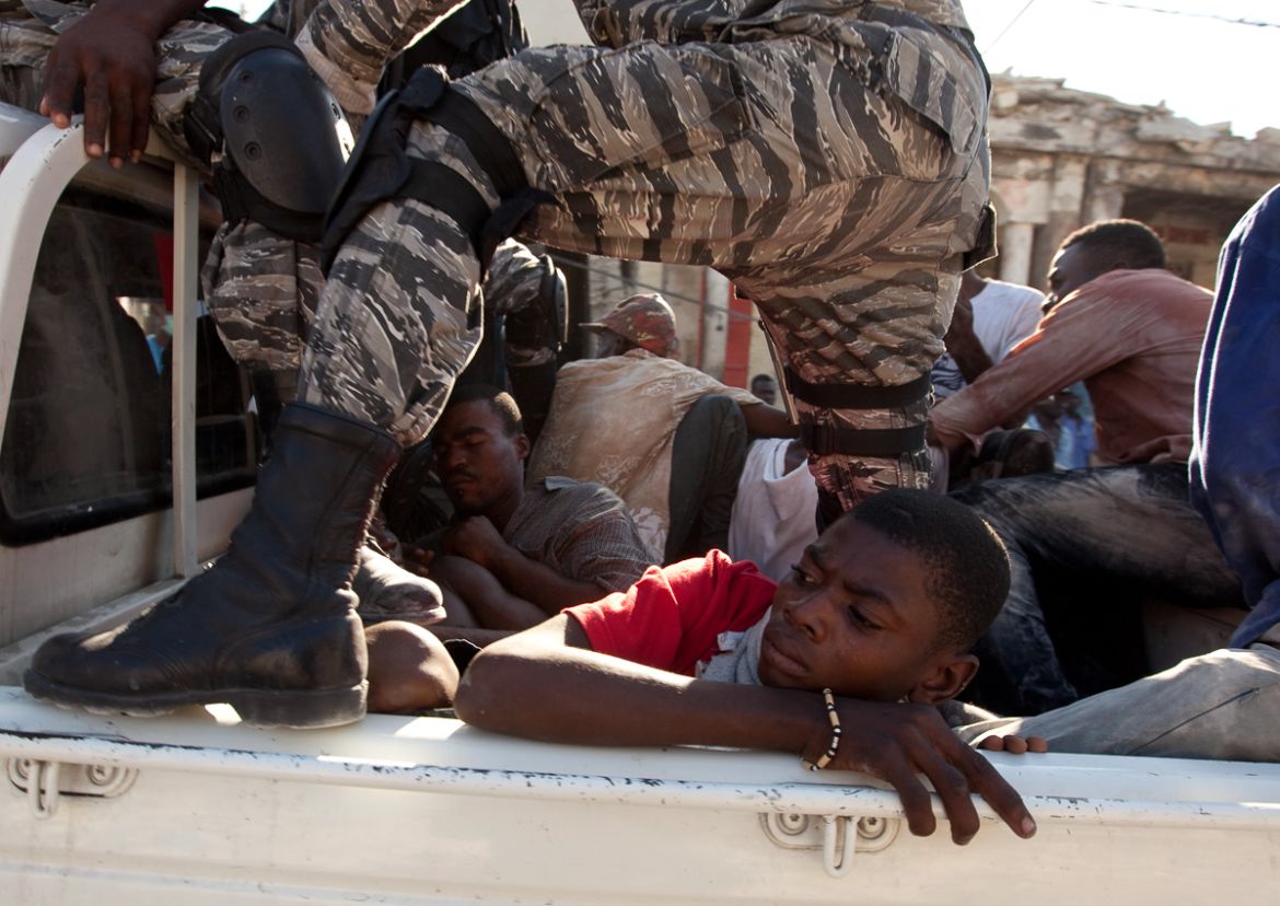 Police officers detain alleged looters in Port-au-Prince, Friday, Jan. 15, 2010. A powerful earthquake hit Haiti Tuesday. (AP Photo/Ramon Espinosa)