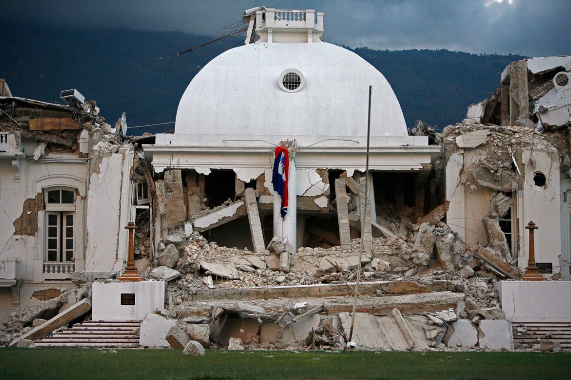 The center dome of Haiti''s National Palace is seen collapsed after a 7.0-magnitude earthquake struck Port-au-Prince, Haiti, Wednesday, Jan. 13, 2010. (AP Photo/Ricardo Arduengo)