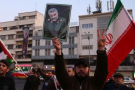 A man holds a picture of late Iranian general Qassem Soleimani in Tehran [File: Nazanin Tabatabaee/WANA]