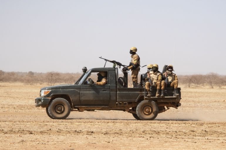 Burkina Faso soldiers patrol aboard a pick-up truck on the road from Dori to the Goudebo refugee camp, on February 3, 2020. OLYMPIA DE MAISMONT / AFP