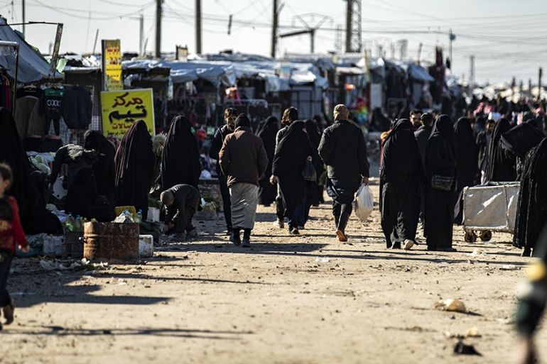 People gather at a market inside the Kurdish-run al-Hol camp for the displaced in the al-Hasakeh governorate in northeastern Syria on January 14, 2020, at the section reserved for Iraqis and Syrians.