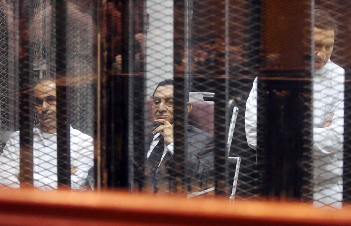 Egypt''s ousted President Hosni Mubarak sits next to his sons Gamal (L) and Alaa (R) inside a dock at the police academy on the outskirts of Cairo May 21, 2014. An Egyptian court on Wednesday sentenced