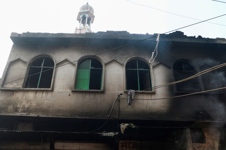 A burnt-out mosque and shops are seen following clashes between people supporting and opposing a contentious amendment to India''s citizenship law, in New Delhi on February 26, 2020. - Four more people