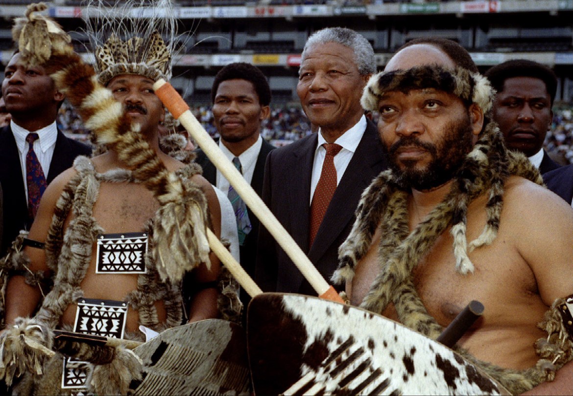 African National Congress President (C) Nelson Mandela arrives at a Sonke Festival campaign rally for the April 1994 presidential elections October 24. At left is southern Natal ANC chairman Jeff Rade