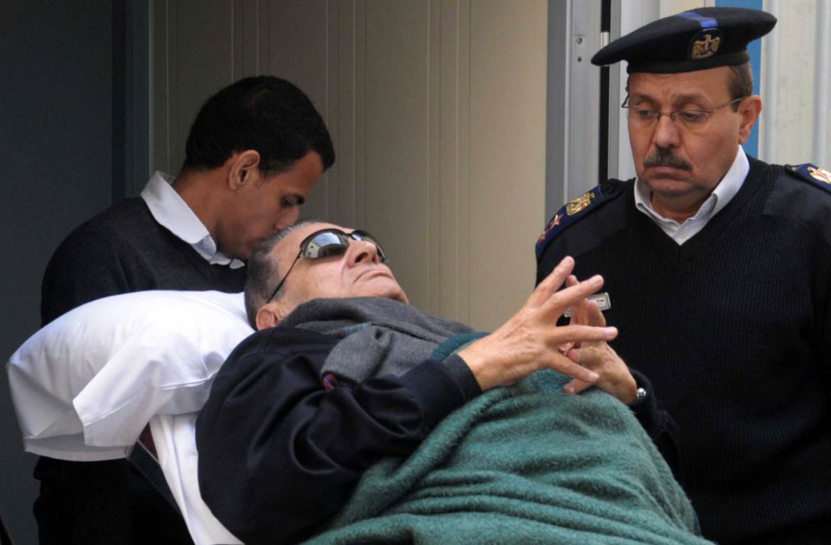 Former Egyptian president Hosni Mubarak lies on a gurney bed while leaving the courtroom at the police academy, where he is on trial, in Cairo January 2, 2012. REUTERS/Stringer (EGYPT - Tags: POLITIC