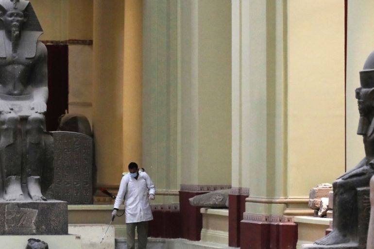 A member of a medical team sprays disinfectant inside the Egyptian Museum in Cairo