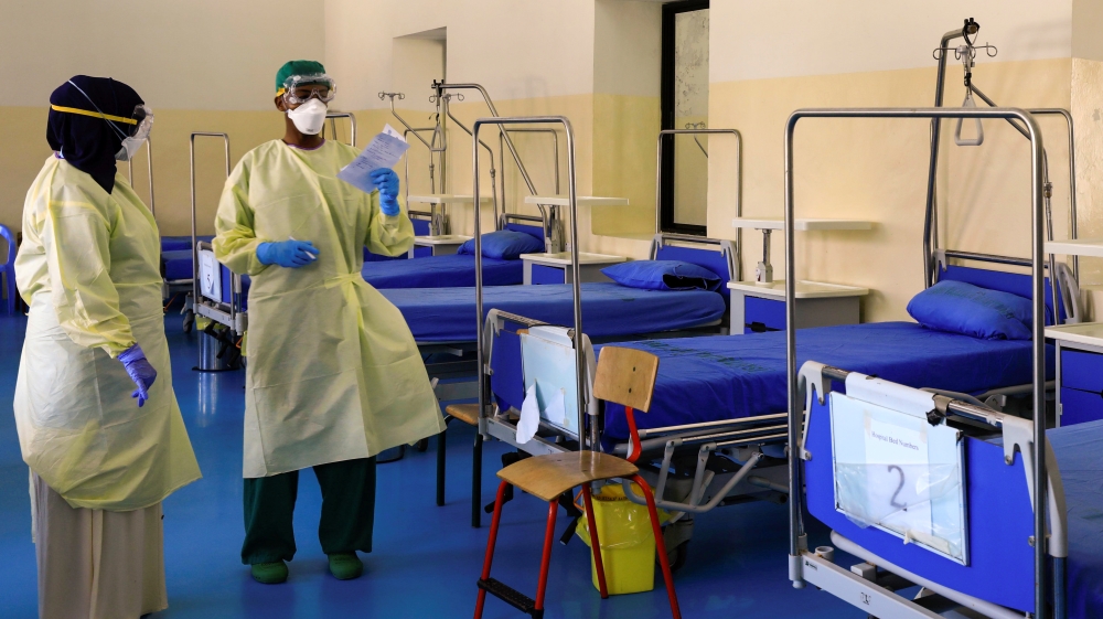 A Somali doctor and a nurse wear protective face masks as they prepare a ward for coronavirus disease (COVID-19) patients, at the Martini Hospital in Mogadishu