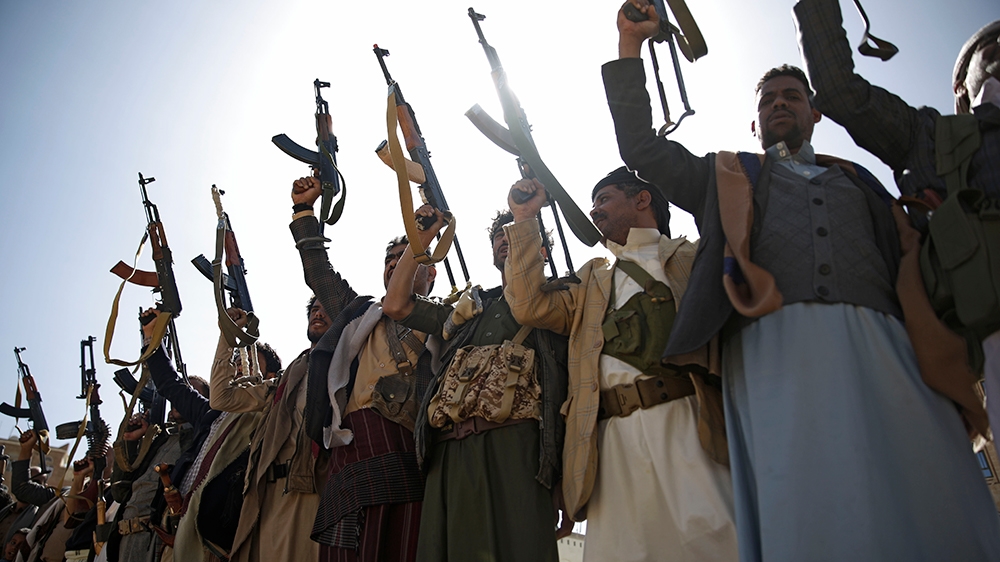 Houthi rebel fighters chant slogans as they hold their weapons during a gathering aimed at mobilizing more fighters for the Houthi movement, in Sanaa, Yemen, Thursday, Feb. 20, 2020. (AP Photo/Hani Mo