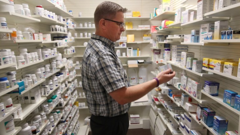 Pharmacist Thomas Jensen, looks over a prescription drug at the Rock Canyon pharmacy in Provo, Utah