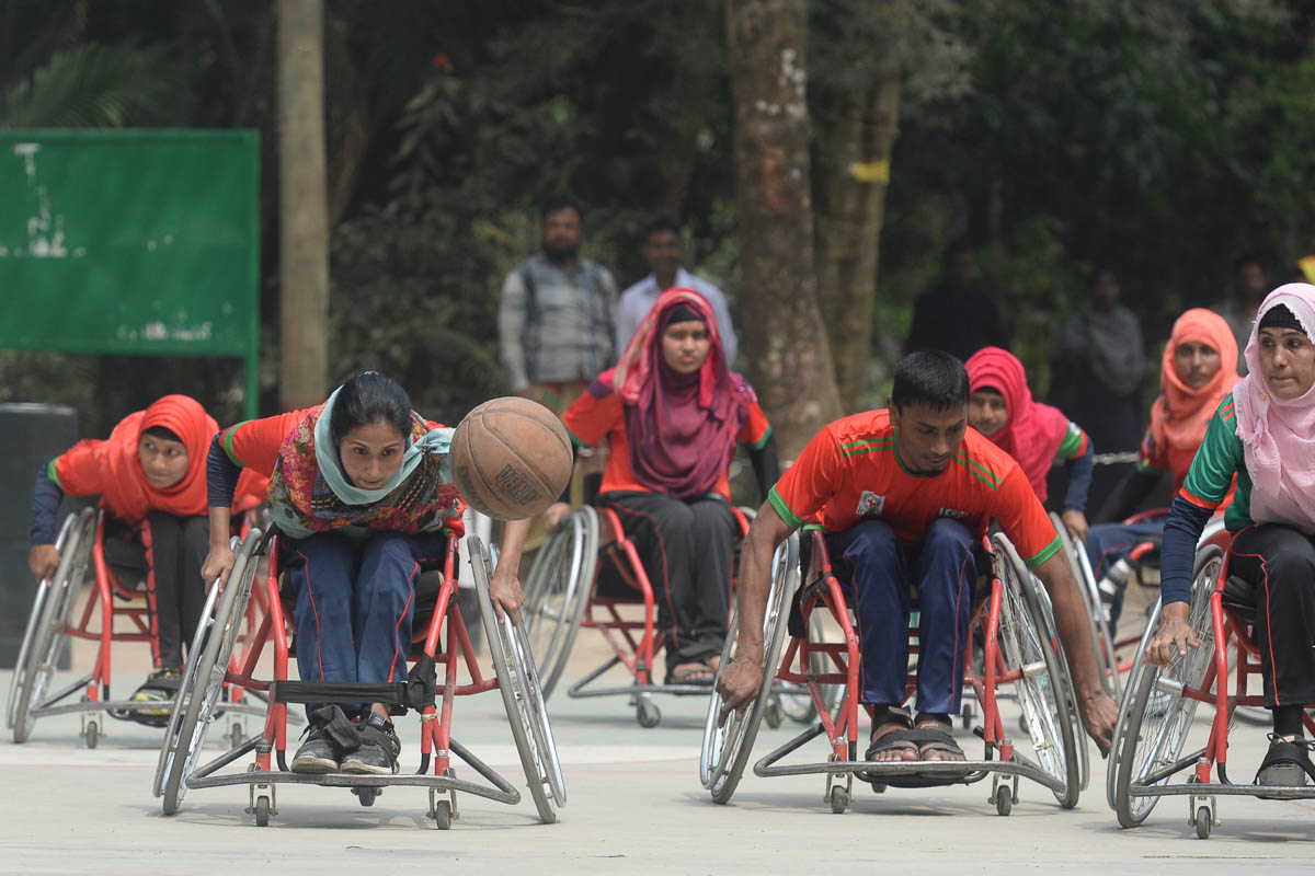 Bangladeshi wheelchair basketball players including men and women play during a friendly match jointly organised by the Centre for Rehabilitation of the Paralysed (CRP) and the International Committee