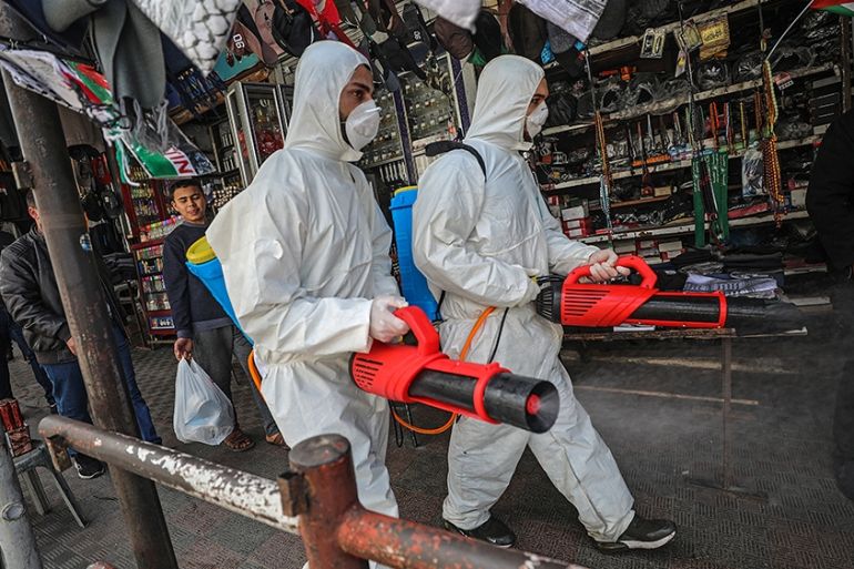 epa08306457 Palestinians spray disinfectant as a precaution against the spread of the Covid-19 coronavirus, in Gaza City, 19 March 2020. Countries around the world are taking increased measures to ste