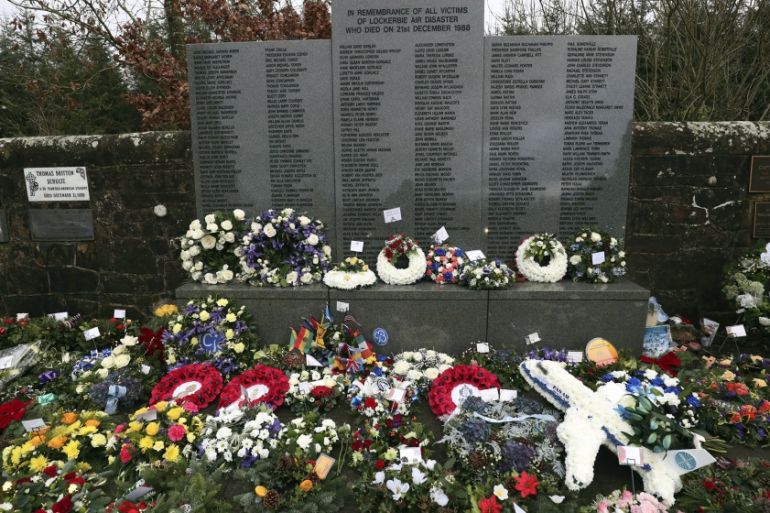 A general view of floral tributes which have been laid by the main memorial stone in memory of the victims of Pan Am flight 103 bombing, in the garden of remembrance at Dryfesdale Cemetery, near Locke