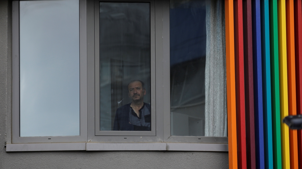 Man looks out from a dormitory where he is placed under quarantine in Istanbul