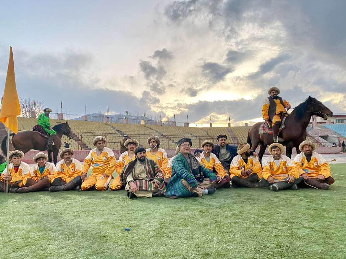 Buzkashi players and their coach Taaj Baig from Kunduz province poses for a team photo in Ghazi stadium ahead of the inauguration of the first-ever Buzkashi League on March 7. Photo by Hikmat Noori.