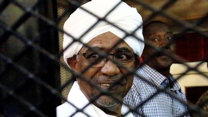 Sudan''s former president Omar Hassan al-Bashir smiles as he is seen inside a cage at the courthouse where he is facing corruption charges, in Khartoum, Sudan August 31, 2019. REUTERS/Mohamed Nureldin