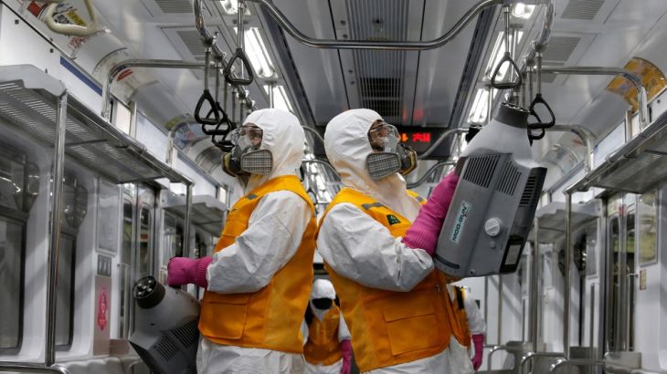 Employees from a disinfection service company sanitize a subway car depot amid coronavirus fears in Seoul, South Korea, March 11, 2020. REUTERS/Heo Ran TPX IMAGES OF THE DAY