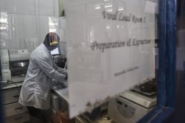 A lab technician works inside the viral load room at the Thyolo District hospital on November 26, 2014. The World Health Organization (WHO) says there were some 35 million people around the world livi