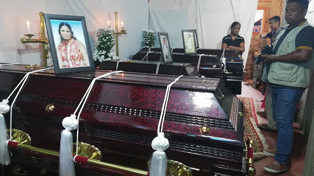 The coffins of the four family members  [Aanya Erinyes/Al Jazeera]
