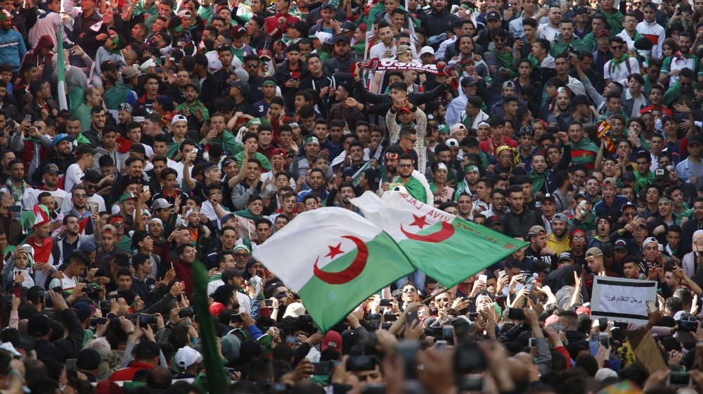 Demonstrators wave the Algerian flag as thousands gather for a rally in Algiers, Friday April 5, 2019, chanting, singing and cheering after their movement forced out longtime President Abdelaziz Boute