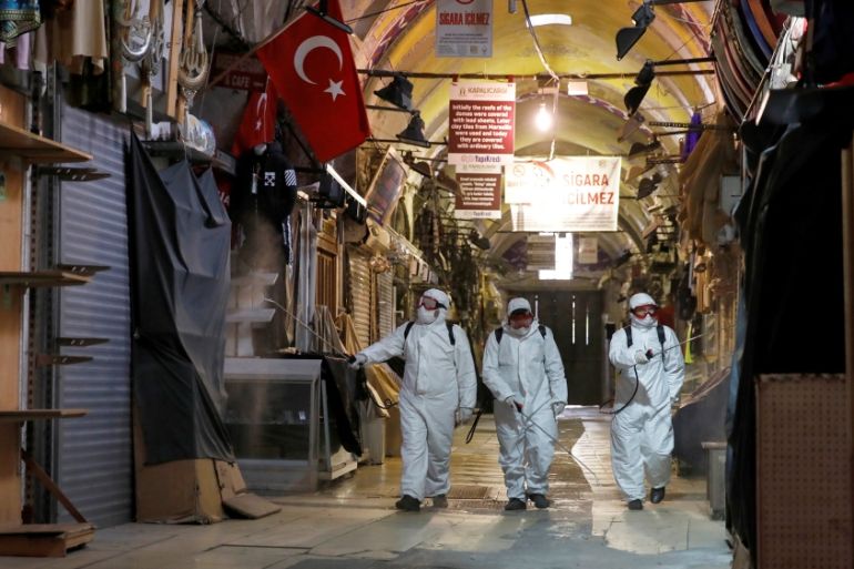 Workers in protective suits spray disinfectant at Grand Bazaar, known as the Covered Bazaar, to prevent the spread of coronavirus disease (COVID-19), in Istanbul, Turkey, March 25, 2020. REUTERS/Umit