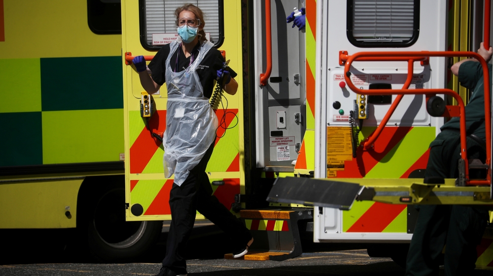 A medical worker wearing personal protective equipment (PPE) at the back of an ambulance outside Lewisham hospital as the spread of the coronavirus disease (COVID-19) continues, London, Britain, April