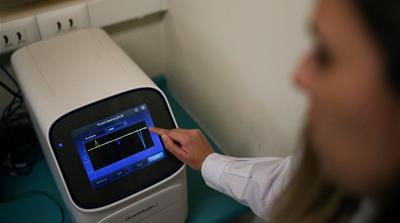 A technician shows a PCR thermal cycler used for diagnose coronavirus cases at the Public Health Institute of Chile (ISP) in Santiago