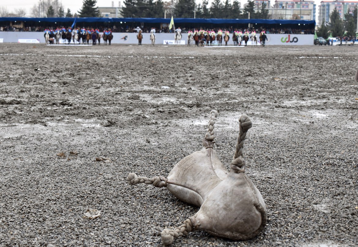 A sheepskin bag filled with sand waits to be picked up by Buzkashi players ahead of the game, on the second day of the Buzkashi league at Chaman-e-Hazouri stadium in Kabul. Photo by Hikmat Noori