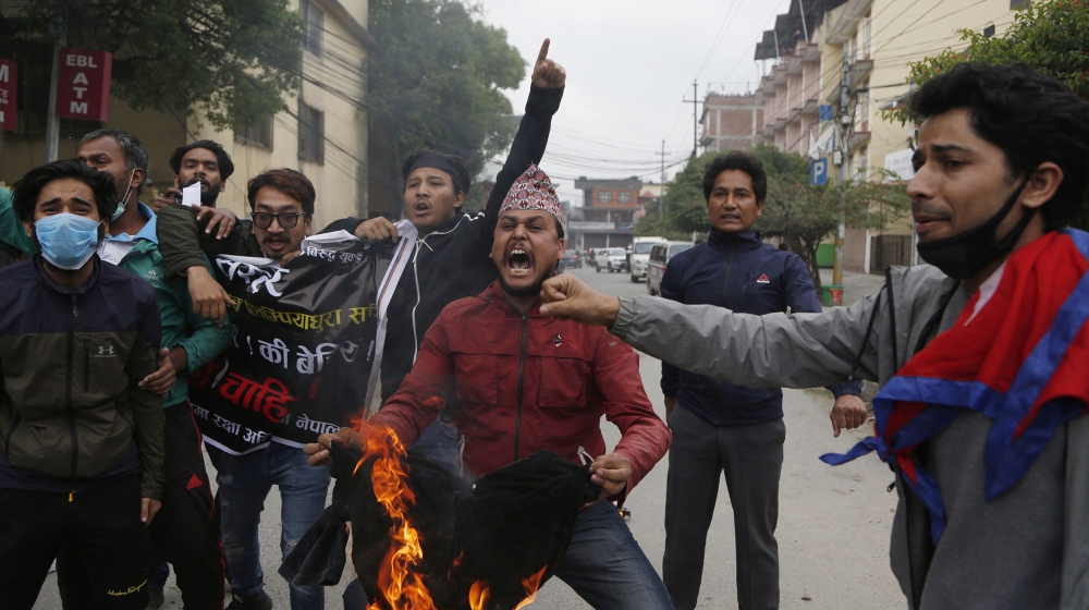 Nepalese students shout slogans during a protest amid lockdown in Kathmandu, Nepal, Monday, May 11, 2020. The protest was held against the Indian government Friday inaugurating a new road through a di