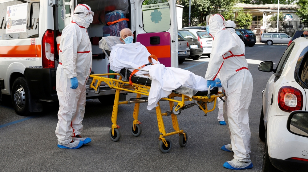 A patient is carried on a stretcher from a nursing home to a hospital, as the spread of the coronavirus disease (COVID-19) continues, in Rome, Italy, May 2, 2020. REUTERS/Remo Casilli