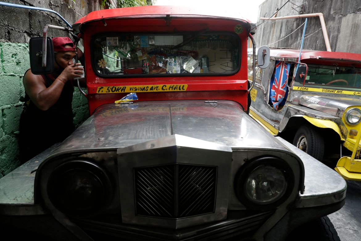 A jeepney driver drinks coffee beside his vehicle at the Tandang Sora terminal which have been home for them since a lockdown started three months ago, on Wednesday, June 17, 2020 in Quezon city, Phil