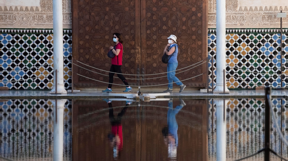 epa08490308 The first visitors walk at Alhambra Palace  that has reopened in Granada, Spain, 17 June 2020, with a 50 percent of its capacity and 4,250 tickets per day. The visit has some itinerary mod