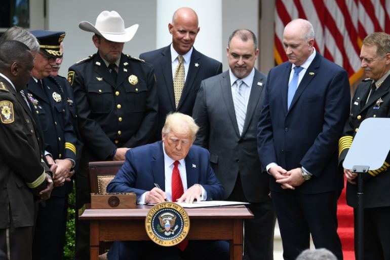 US President Donald Trump signs an Executive Order on Safe Policing for Safe Communities, in the Rose Garden of the White House in Washington, DC, June 16, 2020. SAUL LOEB / AFP