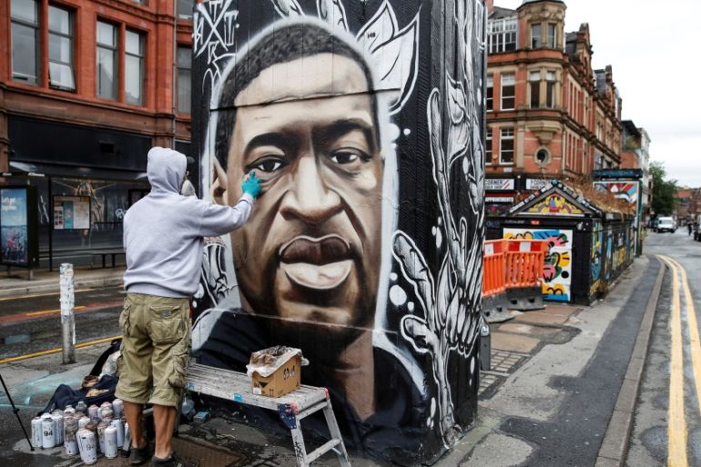 Artist Akse works on a mural of George Floyd who died in police custody in Minneapolis, Stevenson Square, Manchester, Britain, June 3, 2020. REUTERS/Phil Noble TPX IMAGES OF THE DAY