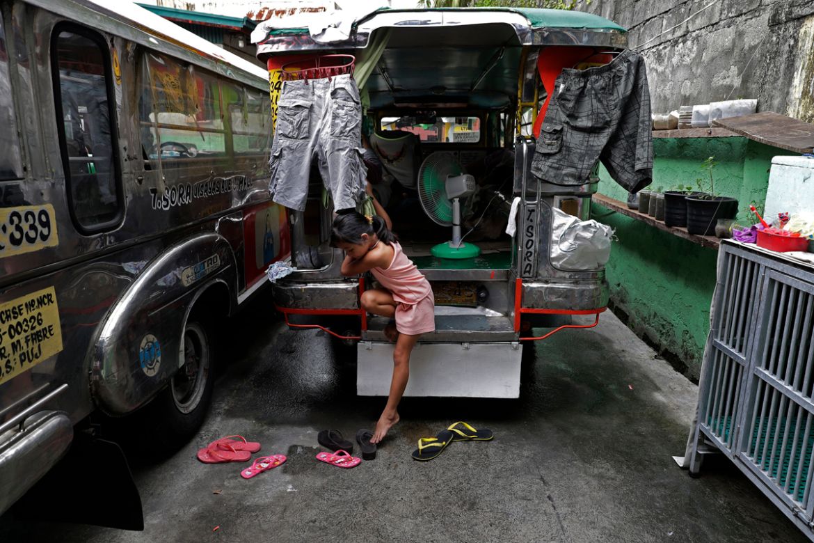 Seven-year-old Yuna Recio comes down from their passenger jeepney at the Tandang Sora terminal which have been home for her family during a lockdown, on Wednesday, June 17, 2020 in Quezon city, Philip