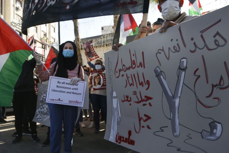 Palestinians demonstrate against Israeli plans for the annexation of parts of the West Bank, in the in the West Bank city of Ramallah, Wednesday, July 1, 2020.The Arabic reads : " This is how we under