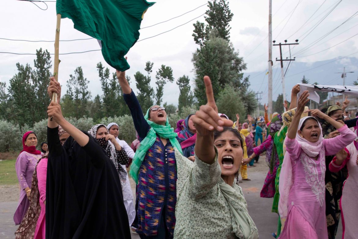 Women shout slogans and march on a street after Friday prayers in Srinagar, Indian controlled Kashmir, Friday, Aug. 9, 2019. A strict curfew in Indian-administered Kashmir in effect for a fifth day wa