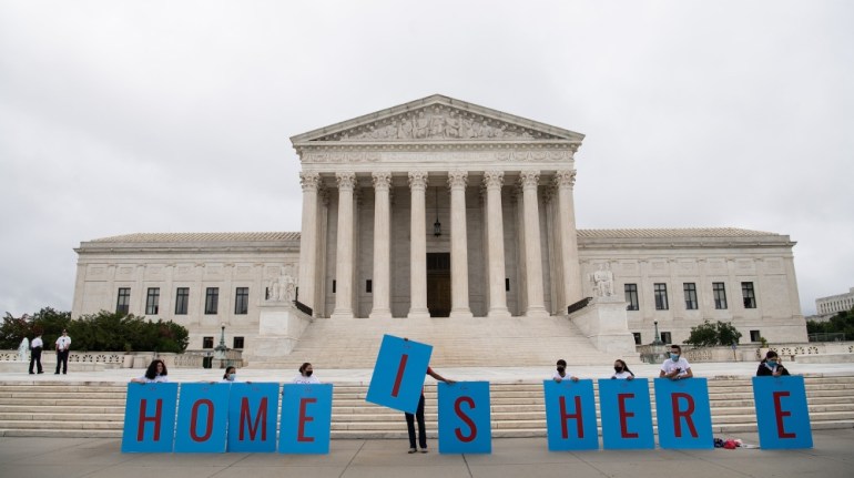 Activists hold a banner in front of the US Supreme Court in Washington, DC, on June 18, 2020. The US Supreme Court rejected President Donald Trump''s move to rescind the DACA program that offers protec