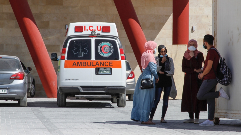 A group of nurses prepare to leave the Dura Hospital after the end of their shift.