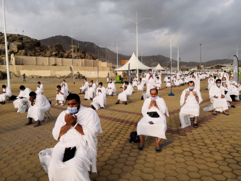 Muslim pilgrims pray near the Mercy mountain in Arafat as they distance themselves to protect against coronavirus during the annual hajj pilgrimage near the holy city of Mecca, Saudi Arabia, Thursday,