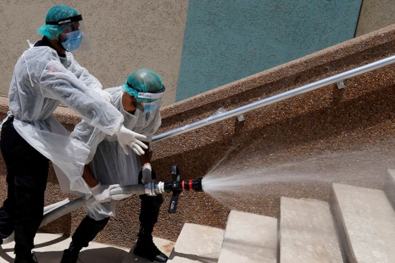 Members of Palestinian security forces loyal to Hamas spray disinfectants during a simulation exercise for preventing the spread of the coronavirus disease (COVID-19), in Gaza City July 18, 2020. Pict