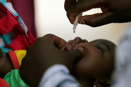 A child is given a dose of polio vaccine at an immunisation health centre, in Maiduguri, Borno State, Nigeria, August 29, 2016 [File: Afolabi Sotunde/Reuters]